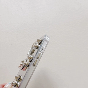 Macro side view of clear phone case with 3D silver bear and precise cutouts