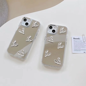 Détail de coque iPhone miroir argentée avec cœurs plissés 3D et protection d'objectif