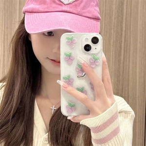Mirror selfie showing 3D purple grape phone case for iPhone with glitter accents