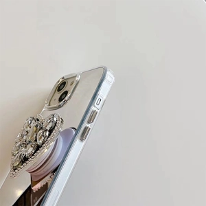 Macro side view of silver plated phone case with sparkling diamond heart phone grip stand