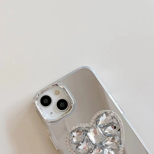 Macro detail of silver mirror phone case with heart-shaped rhinestone socket decoration