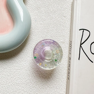Close-up of a sparkling 3D star doughnut phone socket with glitter and sequins