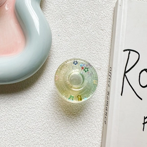 Detail of 3D star doughnut phone socket with colorful sequins and transparent resin