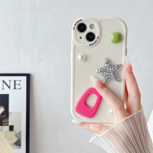 Detail of cream white phone case with 3D pearl star and geometric charms for iPhone
