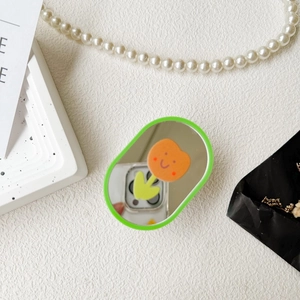 Detail of tulip patterned mirror phone socket holder with vibrant green trim and cute design