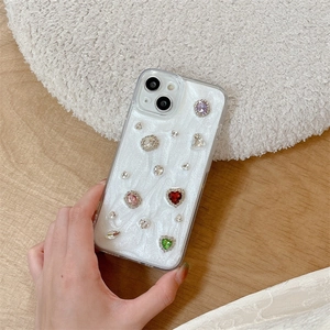 Handheld pearl white iPhone case with colorful rhinestones and gemstone heart decorations