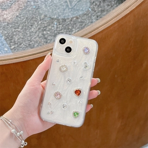 Detail of glitter iPhone case with colorful rhinestones and heart-shaped crystals