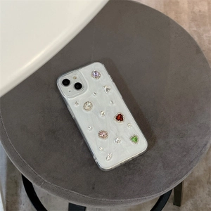 Detail of luxury iPhone case with pearl texture and hand-set heart shaped rhinestones