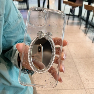Close-up of clear glitter iPhone case with makeup mirror, pearl border and diamond bow