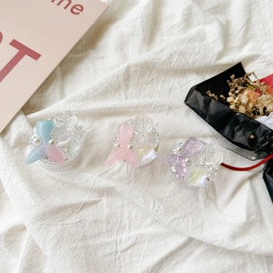 Close-up of floral phone grip accessories with resin mermaid tail and pearl accents