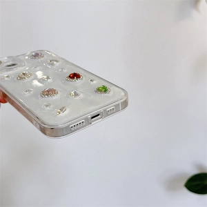 Detailed side view of clear phone case with colorful inlaid gems and precise cutouts