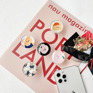 Detail of cute cartoon crystal glass phone grips with various bear and peach designs