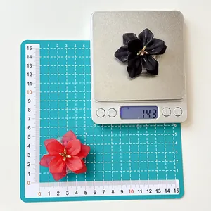 Close-up of matte resin flower phone grip with gold stamen showing dimensions and weight