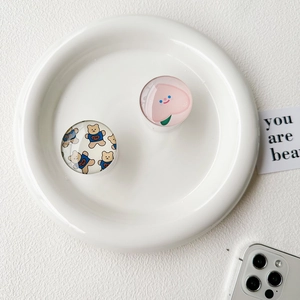 Detail of cute teddy bear and peach patterns on clear crystal glass phone griptoks