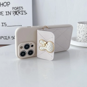 Detail of cream quilted rabbit card holder and matching iPhone case with crossbody strap