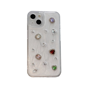 Sparkling iPhone case featuring colorful rhinestones and gemstones on white glitter base