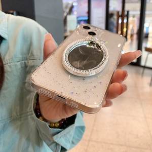 Detail of glitter iPhone case with star sequins and a pearl-rimmed makeup mirror stand