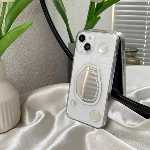Detail of iPhone case with irregular mirror pieces and pearls on white satin fabric