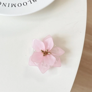 Detailed macro shot of pink flower phone socket with translucent petals and golden stamen
