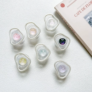 Detail of colorful crystal gem phone grips with glitter finish on textured surface