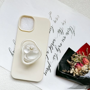 Elegant cream phone case with iridescent pearl resin socket on aesthetic background