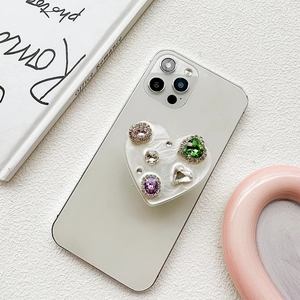 Detailed macro view of heart-shaped phone socket with colorful rhinestones and pearls