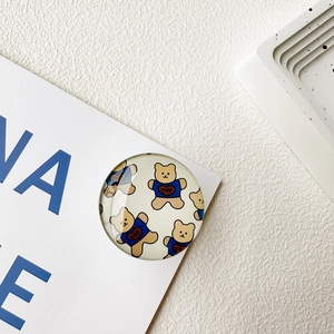 Detail of round crystal glass phone socket with cute cartoon bear and blue top