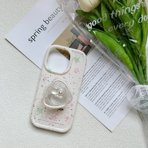Detail of a transparent heart phone grip with pearls on a splatter pattern iPhone case