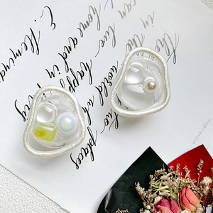 Detail of elegant pearl and gemstone phone grip with vintage floral stationery background