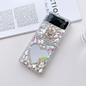 Detail view of luxury Samsung Z Flip case with sparkling crystals, bunny charm, and heart mirror