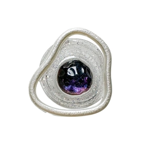 Glittering nebula gemstone phone grip with silver textured metal frame on white background