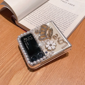 Detail of Galaxy Z Flip clear case featuring 3D rhinestone crown and pearl edge decoration