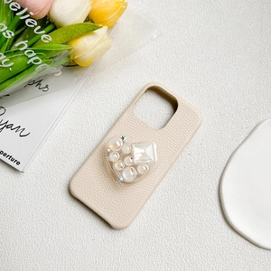 Litchi pattern phone case with heart grip, beads, and gems in a cream beige aesthetic