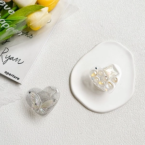 Detailed view of heart-shaped phone grips with glitter butterflies and pearl bead designs