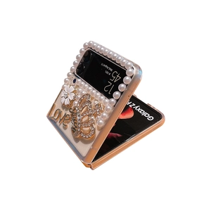 Luxe Samsung Galaxy Z Flip case with white pearls, diamond crown and floral accents