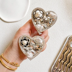 Luxury heart phone grip with camellia, pearls, and rhinestones on a wavy phone case