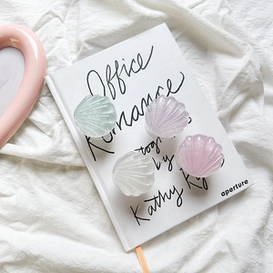 Pink and pastel shell-shaped expanding phone grips in a high-quality aesthetic display