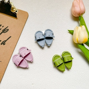 Three pairs of mini 3D shark slipper charms in blue, pink, and green colors for DIY
