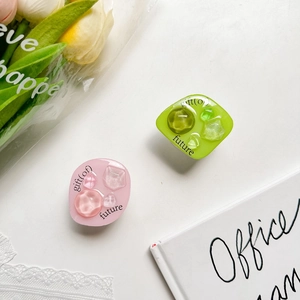 Close-up of pink and green resin phone socket with crystal-like geometric texture