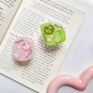 Detail view of crystal resin gemstone phone grips with gift and future typography