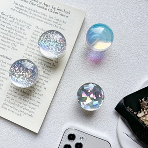 Detailed top view of sparkling crystal ball phone grips with glitter and holographic finish