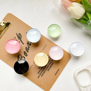 Close-up of colorful translucent round retractable phone grips in various pastel shades