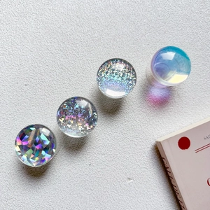 Macro detail of four iridescent crystal ball phone sockets with glitter and laser effects