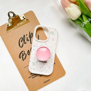 Detail of pink popsocket on white phone case with star patterns and tulip decoration