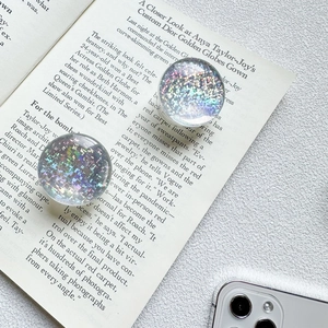 Macro shot of liquid glitter phone grips with silver and holographic laser sequins