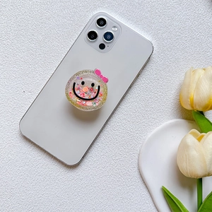 In-style smile glitter phone socket holder with pink bow on white smartphone back
