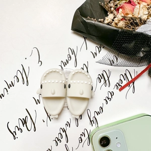 Close-up of cute shark-shaped phone accessories with matte finish on a minimalist desk