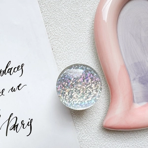 Macro shot of circular crystal phone grip with sparkling laser glitter and sequins