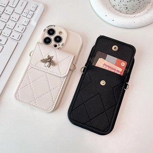 Detail view of quilted leather phone cases with card slots and bee ornaments