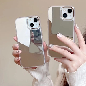 Close-up of slim iPhone mirror case with luxury gold camera frame and silver reflective finish